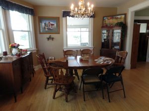 Dining room features antique light fixture