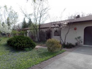 South West style home with attached 2-car garage and paved driveway