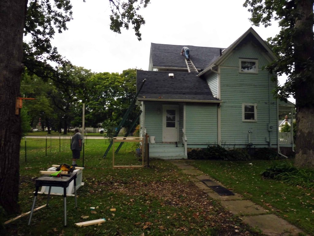 Man on roof of house